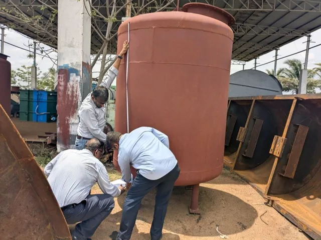 Axium valuers taking physical measurements of a storage tank during a site inspection